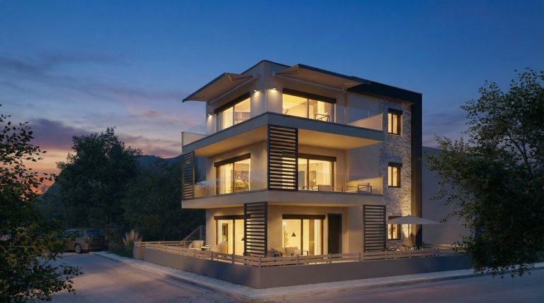 Keli Residence corner view at blue hour, warm interiors, uplit stone wall and awnings over glass balconies
