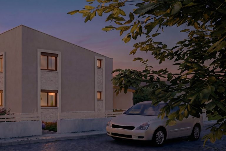 Nea Iraklitsa residence side facade at dusk with stone-framed windows, parked car under tree branches
