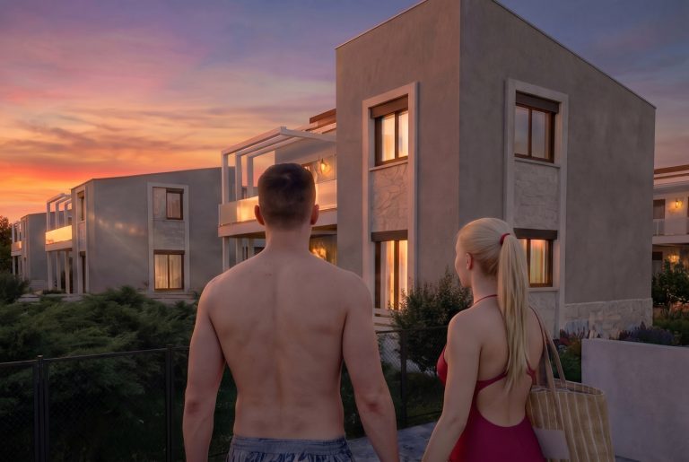 Nea Iraklitsa residence at sunset, couple in swimwear seen from behind looking at the lit facades