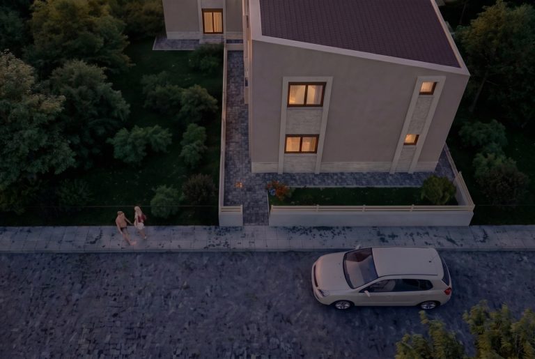 Aerial view of Nea Iraklitsa residence at dusk, couple walking on the sidewalk and a car on the cobbled street
