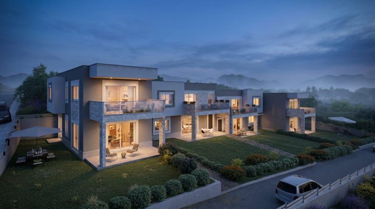 Sikia Vista elevated view of the terraced houses at blue hour, lit terraces and gardens with mountains behind