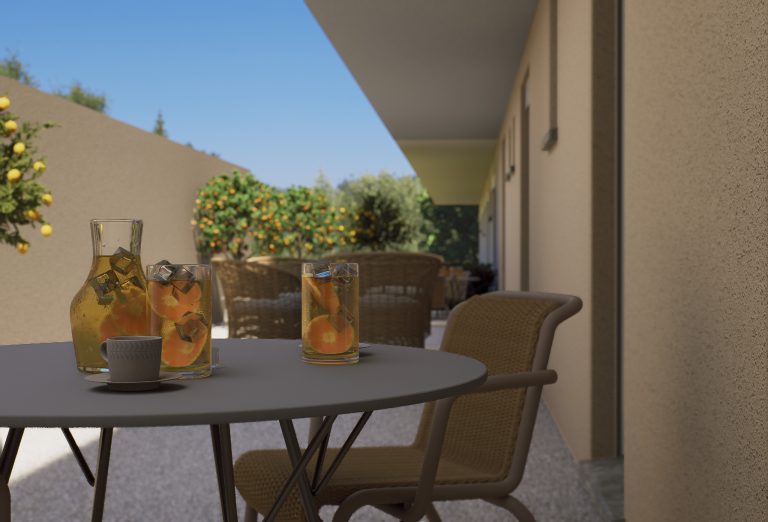 Catherina Residence courtyard table with iced drinks beside the rear wall, orange trees in afternoon sun