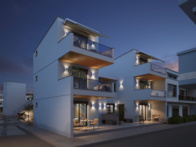 Victoria Residence corner view at blue hour with wall lights, lit terrace and furnished patios along the street
