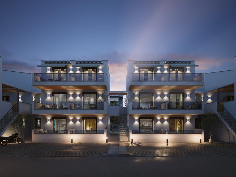 Victoria Residence front elevation at blue hour, the blocks with wall lights, lit rooms and central stair