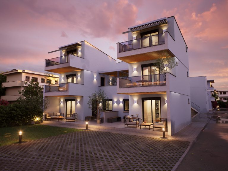 Victoria Residence courtyard facade at sunset under pink clouds with wall lights and garden lounge furniture