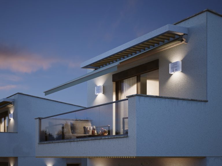Victoria Residence top-floor balcony detail at blue hour with awning, glass railing and glowing wall lights
