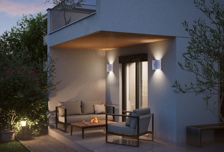 Victoria Residence ground-floor terrace at dusk with lounge sofa, coffee table and warm wall and soffit lights