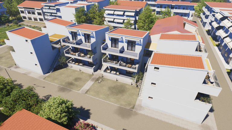 Aerial view of Victoria Residence in daylight, white blocks around paved courtyards in a red-roofed neighborhood
