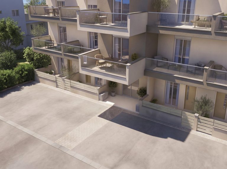 Catherina Residence elevated view of the entrance and stacked balconies over the forecourt in soft afternoon light