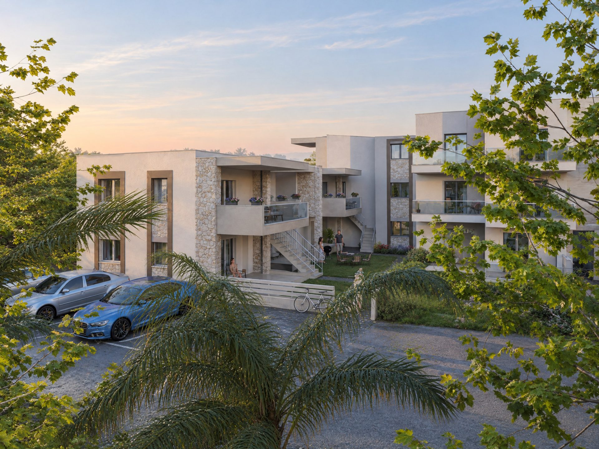Gardenia 3 residential complex at dawn seen over the car park, low morning sun on limestone and white render