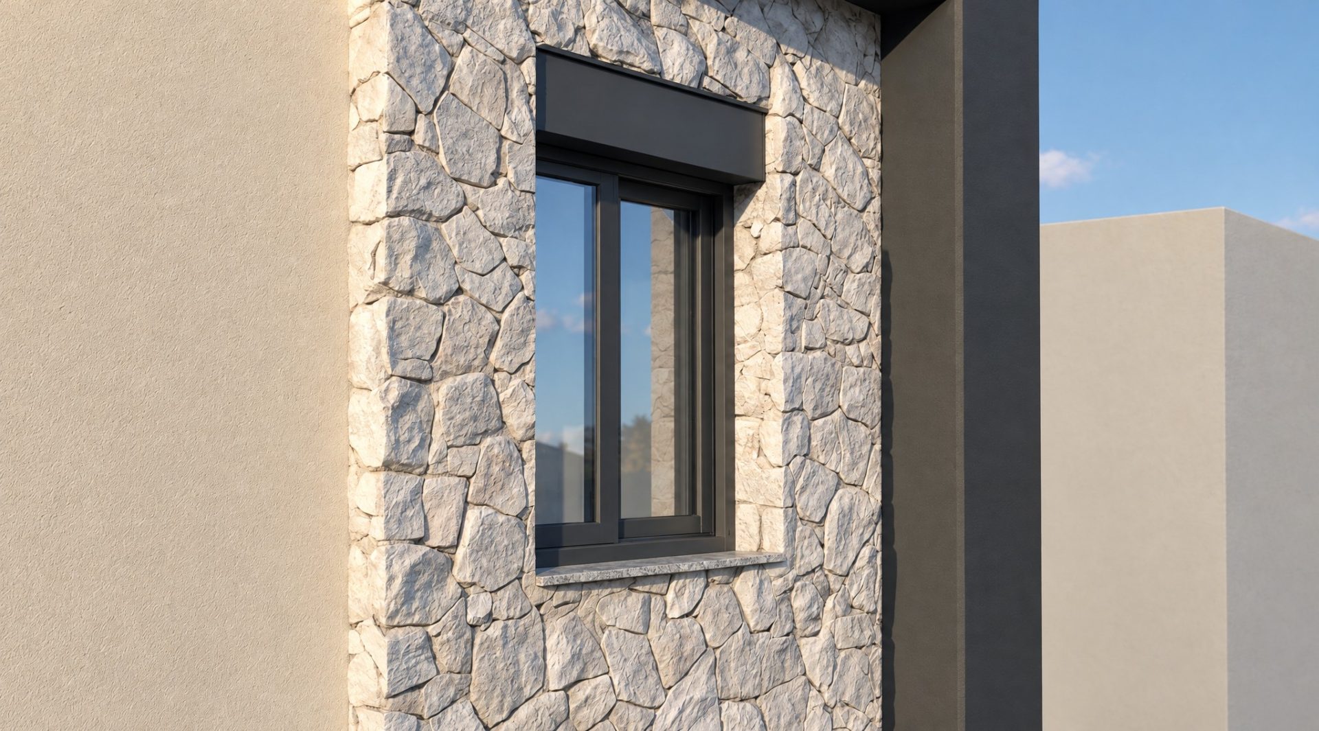 Natural stone cladding and window detail in low late-afternoon light