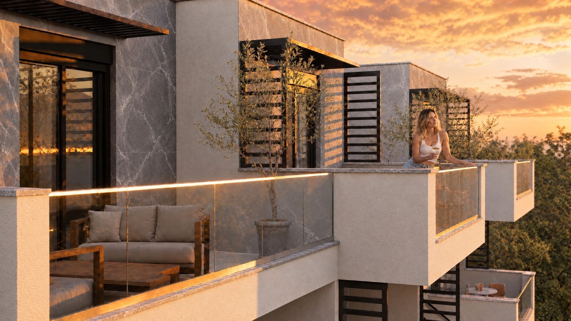 Woman with a glass of wine on the Nika 2 Residence terrace at golden hour