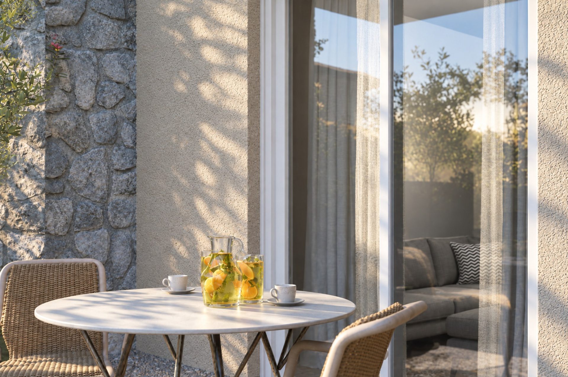 Olympia Residence terrace in early morning sun, coffee cups and lemonade on a round table, stone wall and stucco
