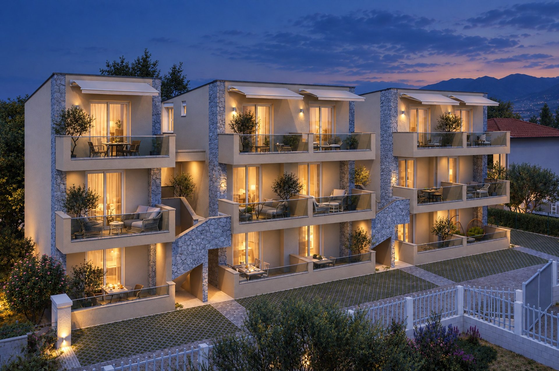 Olympia Residence three apartment blocks at blue hour with warm lights in the windows