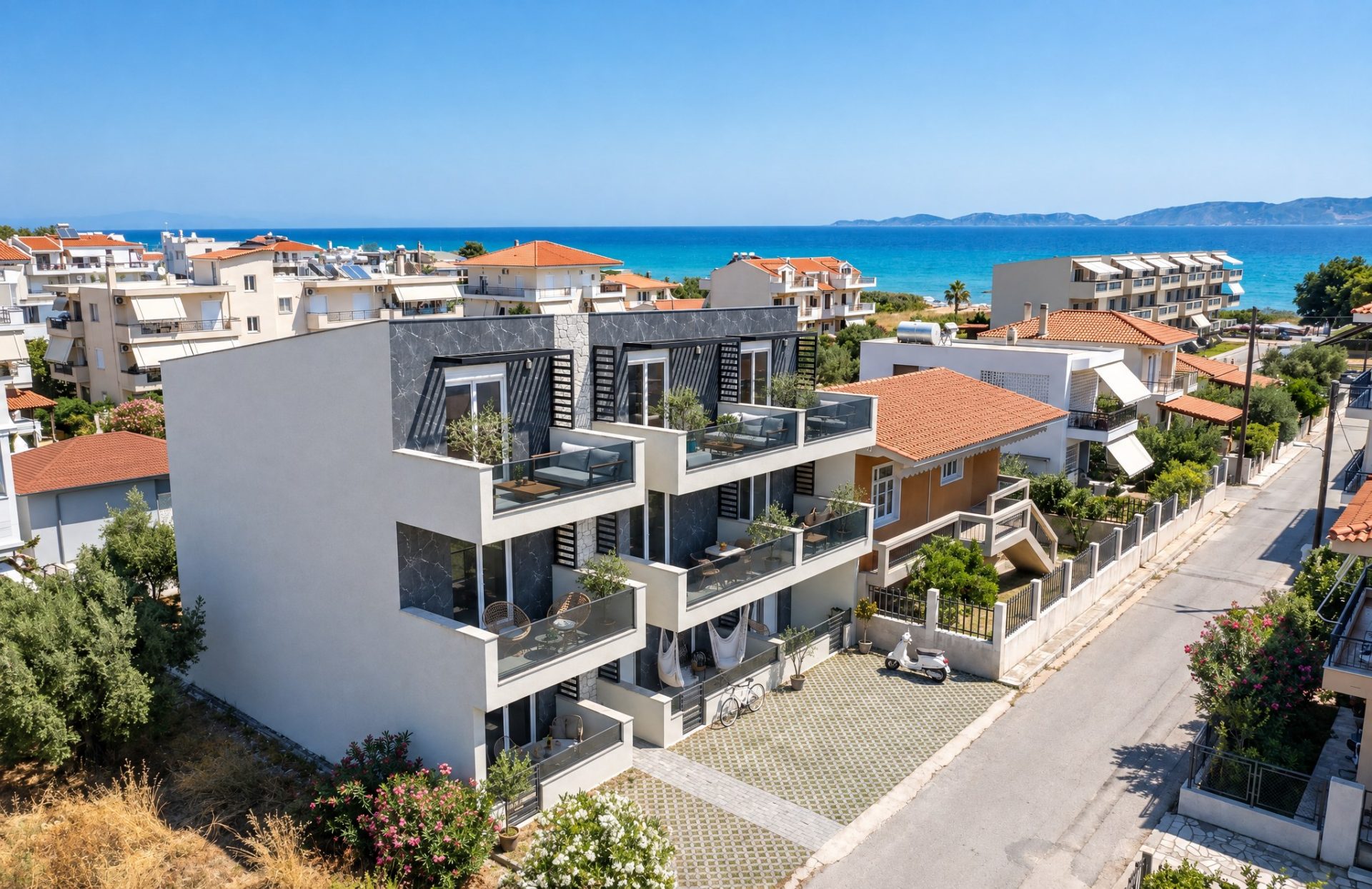 Aerial view of Sia 2 Residence in Ofrinio with the sea at the end of the street, late morning