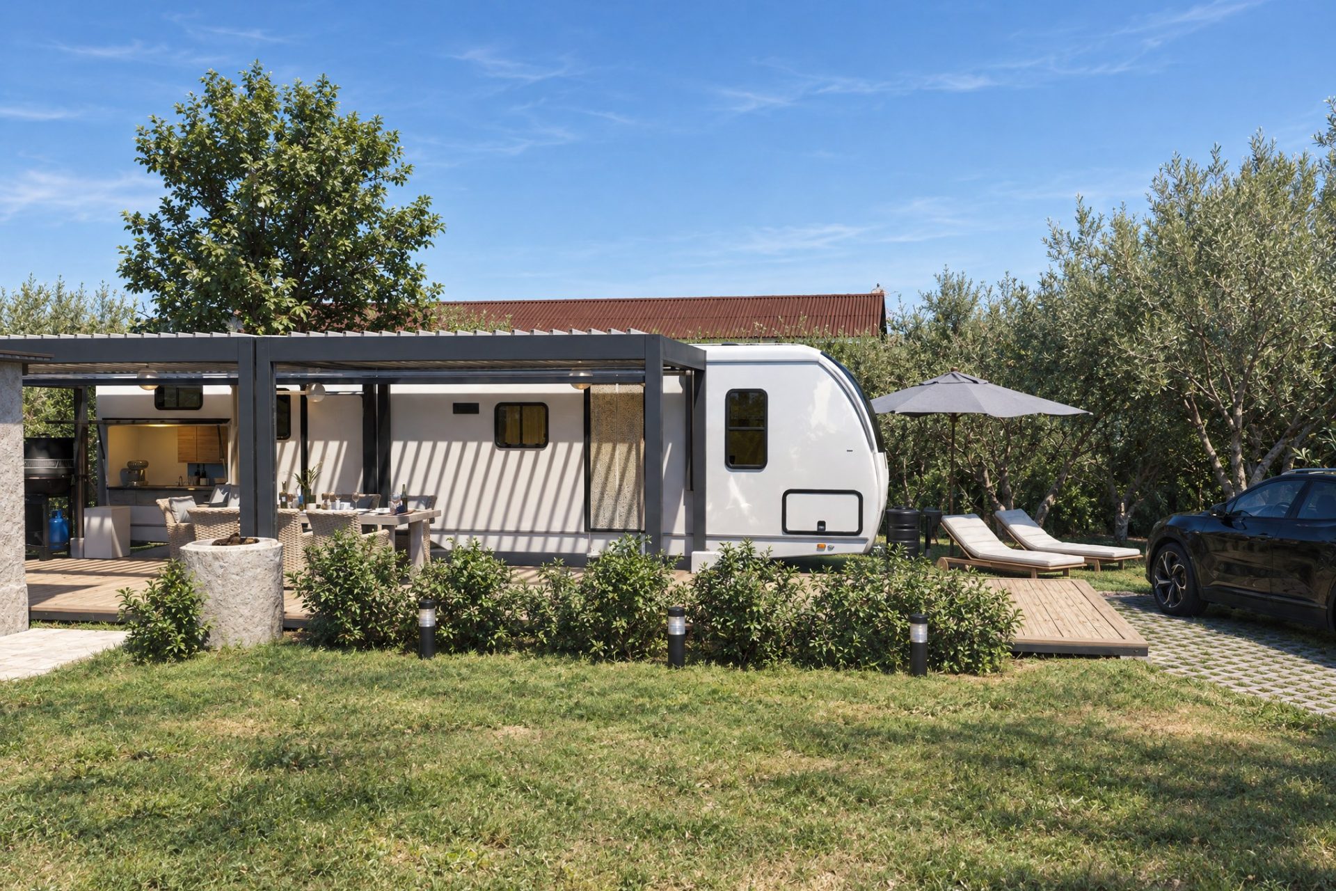 Camper with outdoor kitchen, lounge, dining area, fire pit and sun loungers on the plot in late-morning sun