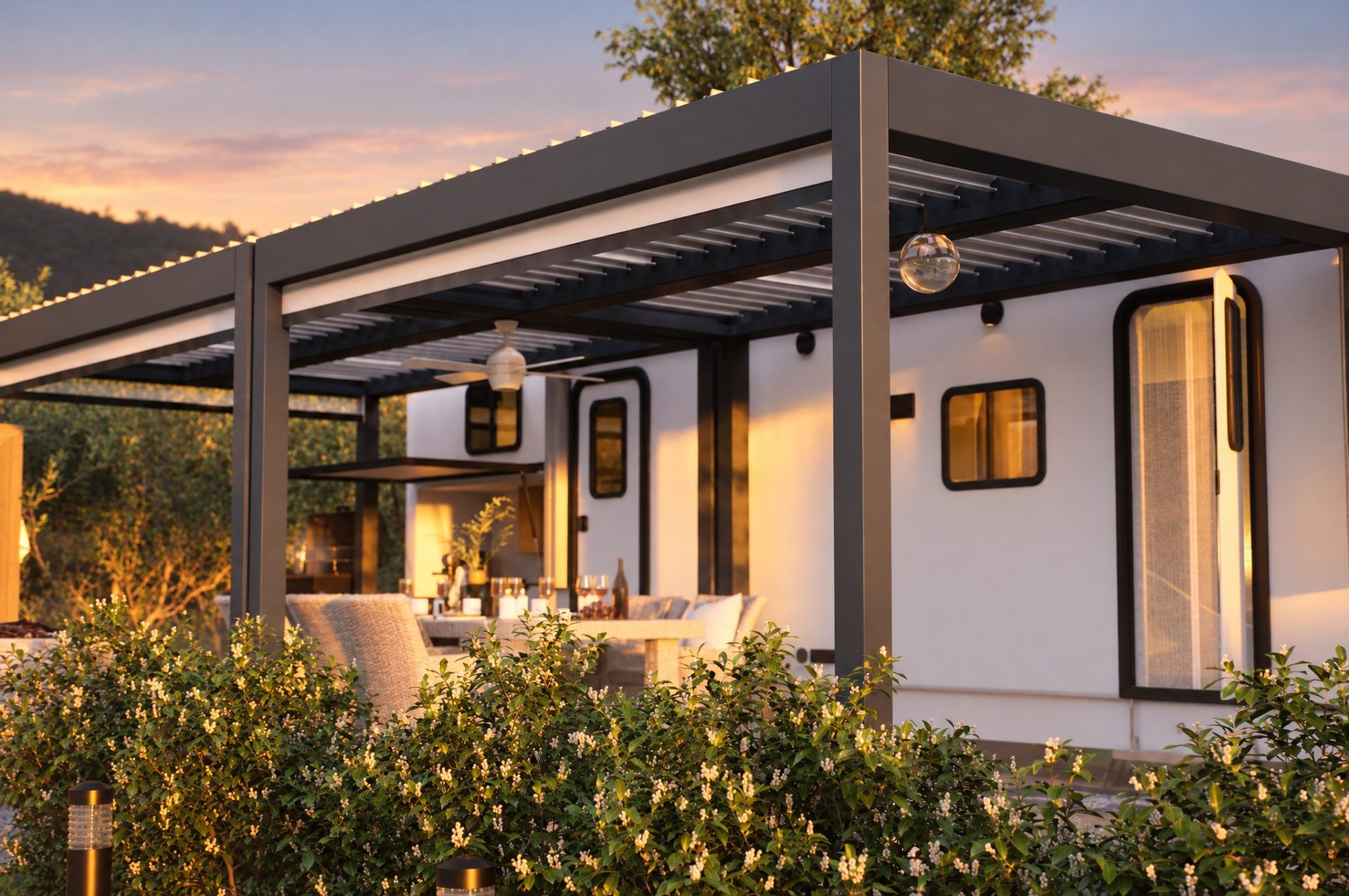 Pergola corner and camper wall at golden hour behind a flowering hedge