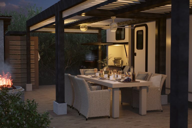 Dining set under the lit pergola in the evening